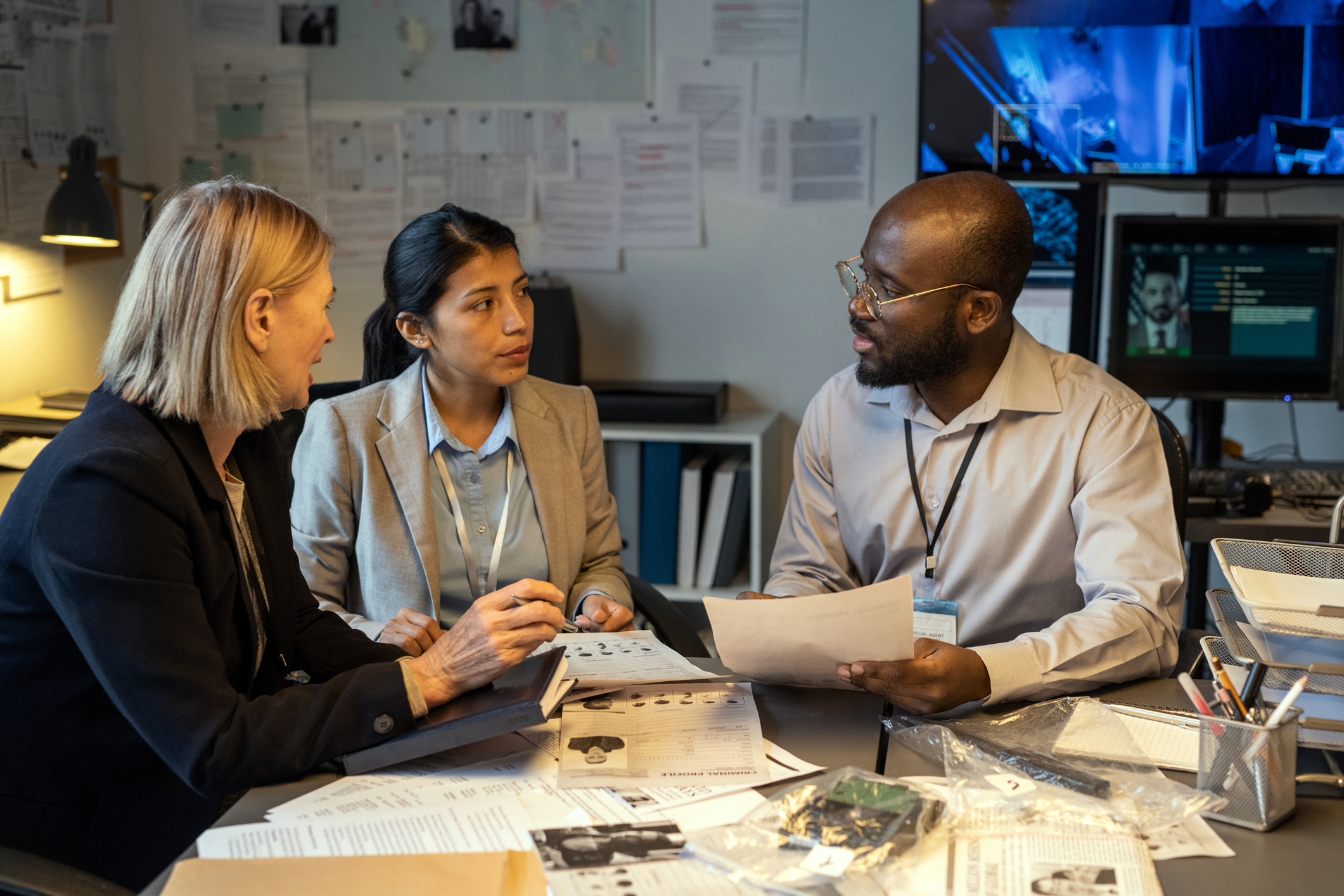 a group of interracial people talking at a table.